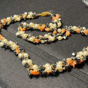 Vintage coral, freshwater pearl and hematite wrapped together in three strands.